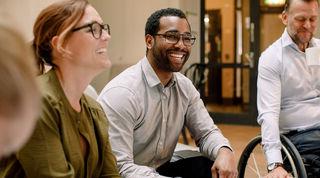 Image of two people interacting in an office environment